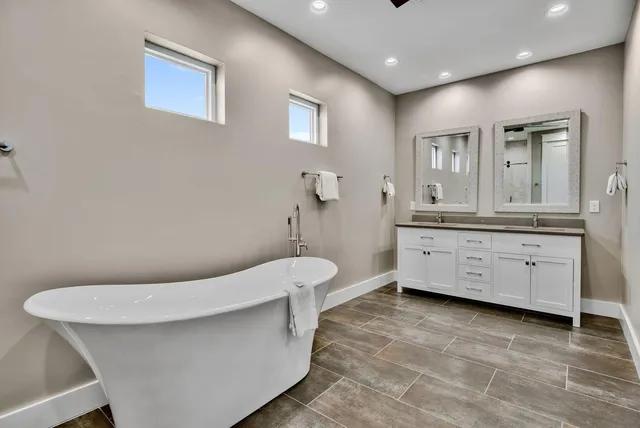 a bathroom with a sink a toilet and mirror