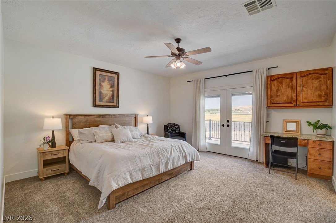 4362 Thistle Street Logandale, NV 89021 - Photo 25 of 99 Step into a comfortable bedroom featuring a balcony overlooking scenic vistas.