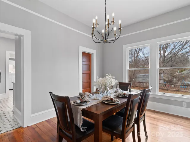 a view of a dining room with furniture wooden floor and chandelier