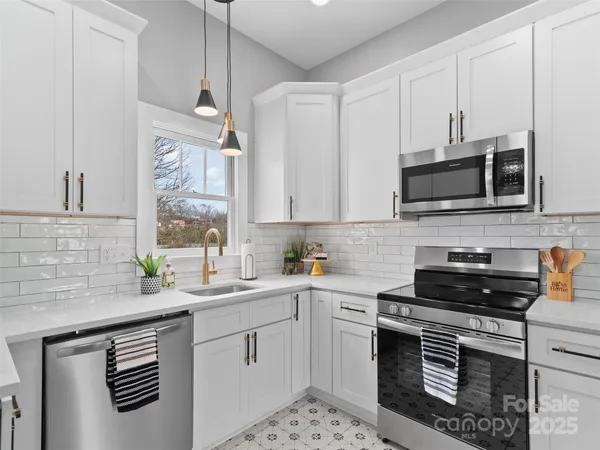 a kitchen with a sink stove and microwave