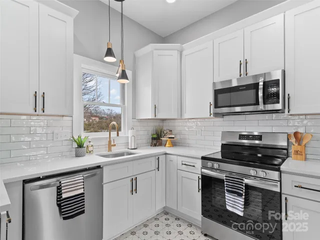 a kitchen with a sink stove and microwave