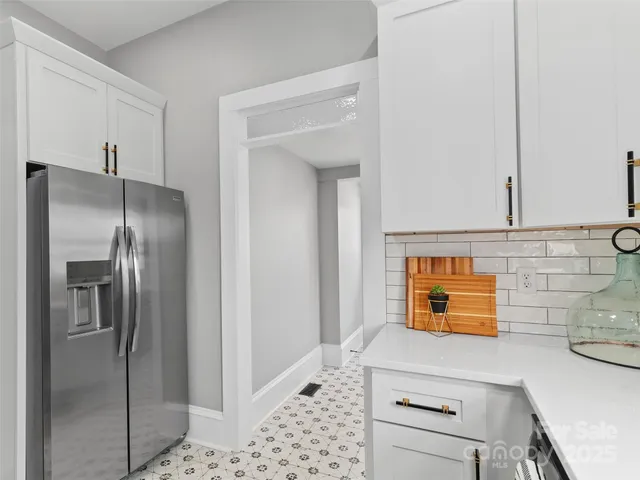 a kitchen with stainless steel appliances kitchen island granite countertop a refrigerator a stove and a sink