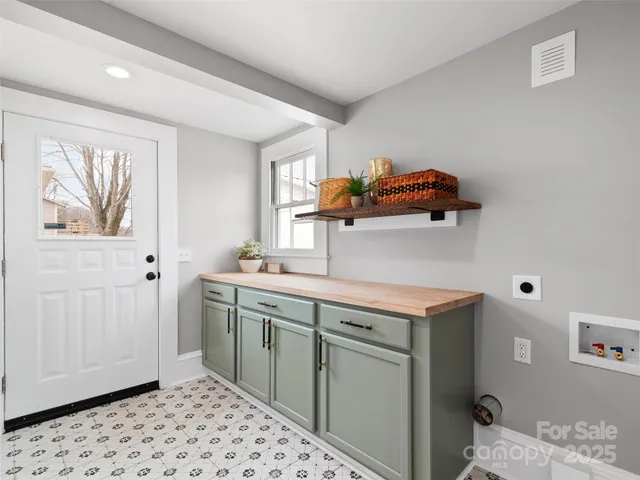 a utility room with a sink dryer and washer