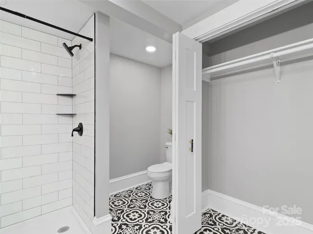 a bathroom with a shower and a toilet