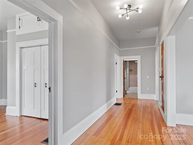 a view of a room with wooden floor