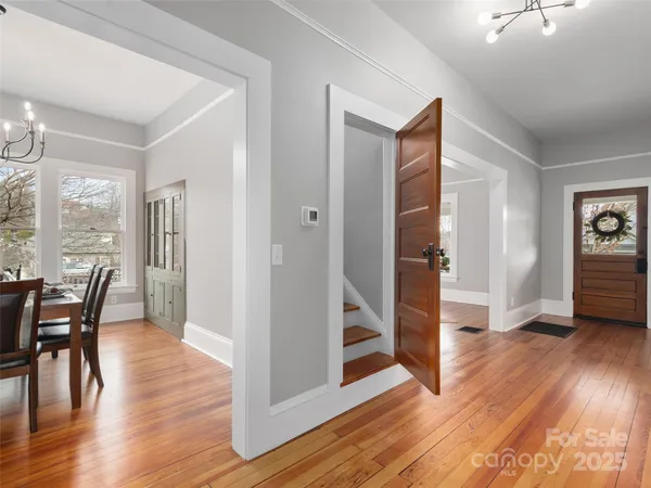 a view of a livingroom with wooden floor and furniture