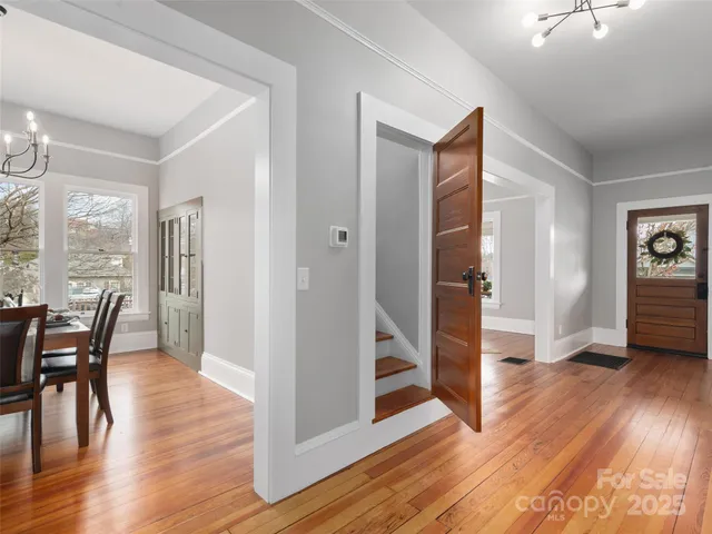 a view of a livingroom with wooden floor and furniture