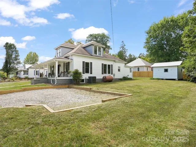 a view of house with outdoor space and swimming pool