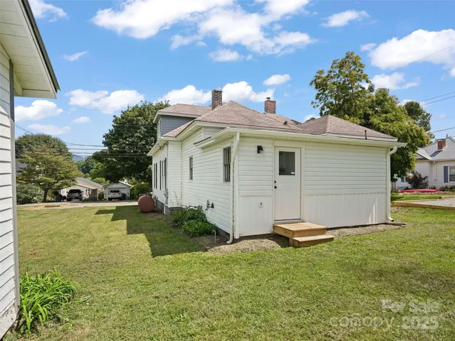 a view of a backyard with plants and a garden