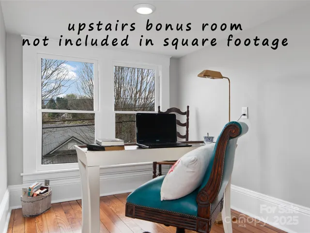 a work room with furniture and wooden floor