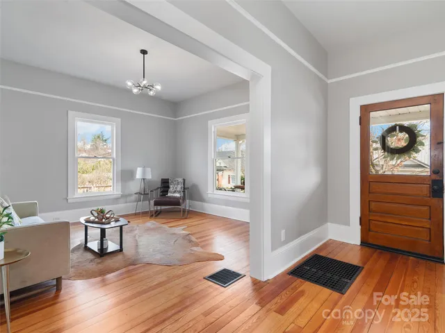 a view of a livingroom with wooden floor and a cabinet