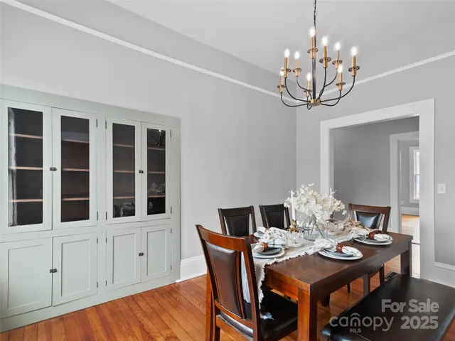 a view of a dining room with furniture wooden floor and chandelier