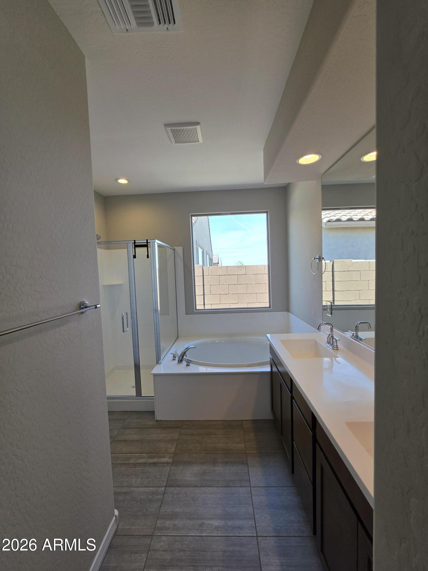 7128 West Coles Road Laveen, AZ 85339 - Photo 14 of 38 a bathroom with a tub sink and mirror
