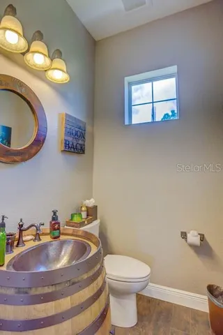 a living room with furniture kitchen view and a large window