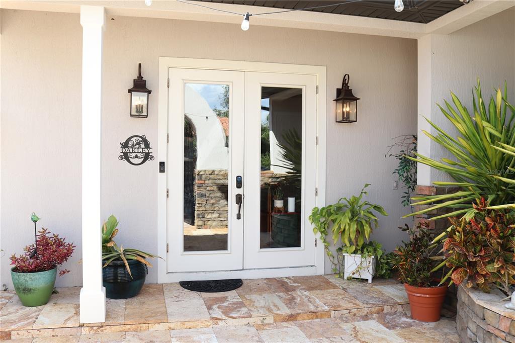 11002 Lake Butler Boulevard Windermere, FL 34786 - Photo 4 of 62 a view of a entryway with flower pots