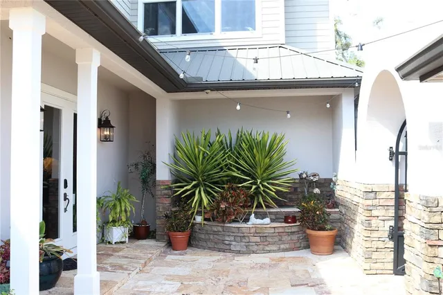 a building outdoor space with patio furniture and potted plants