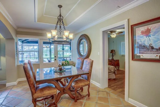 a dining hall with stainless steel appliances granite countertop a sink and a stove