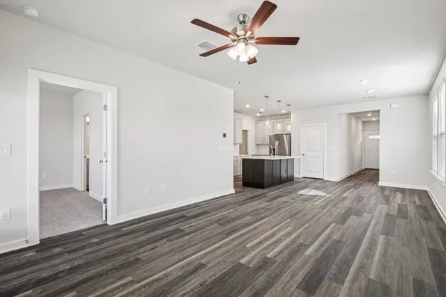 a view of a kitchen with furniture and wooden floor