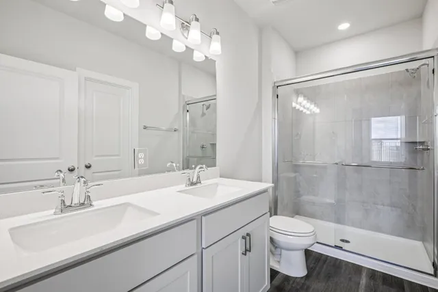 a bathroom with a sink double vanity and a mirror