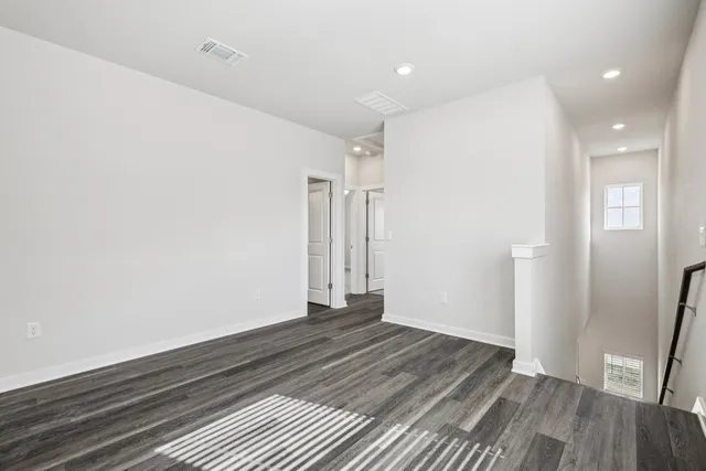 a view of a livingroom with wooden floor and a window