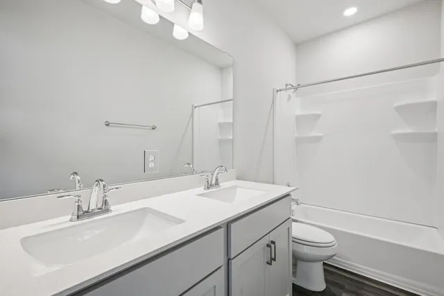 a bathroom with a sink a light fixture and a mirror