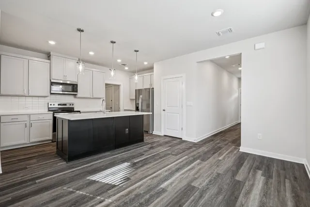 a view of kitchen with granite countertop cabinets and wooden floor