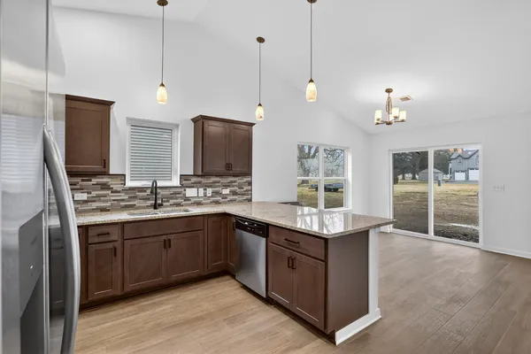 a view of a kitchen island wooden floor and staircase