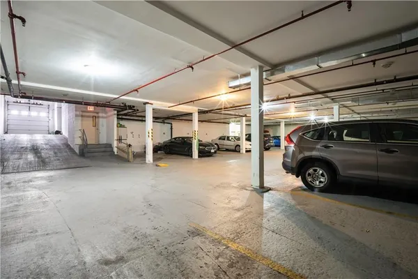 a view of parking garage with cars