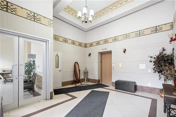 a living room with a large mirror and furniture