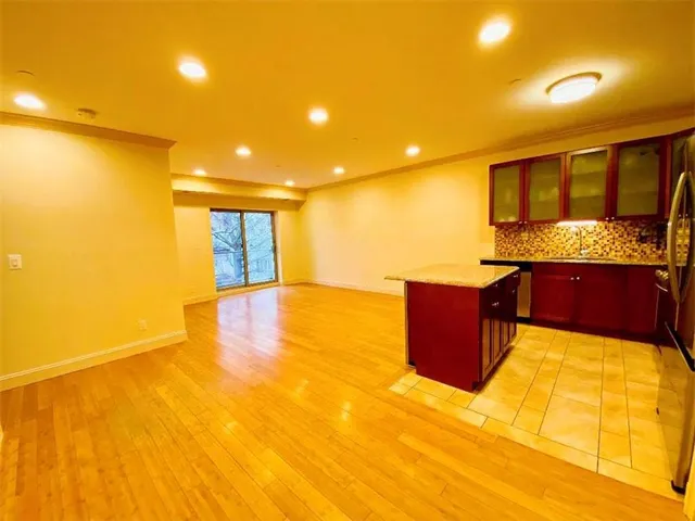 a spacious bathroom with a tub and mirror