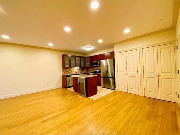 a kitchen with stainless steel appliances kitchen island a refrigerator a stove top oven and a ocean view