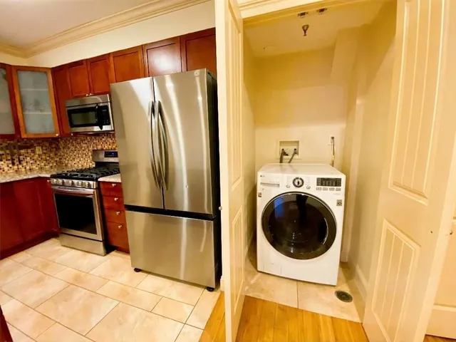 a kitchen with stainless steel appliances granite countertop a refrigerator and a sink