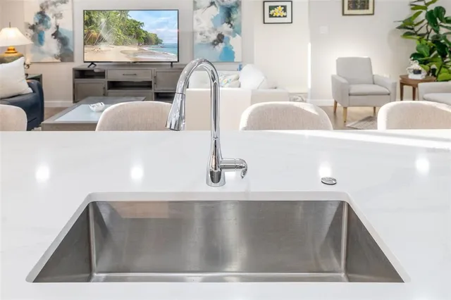 a view of living room with furniture and a potted plant