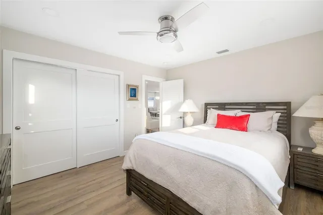 a bedroom with a bed and wooden floor