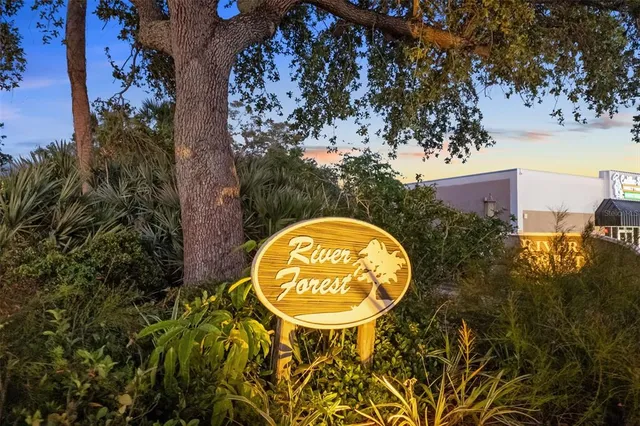 a view of swimming pool with a garden and trees