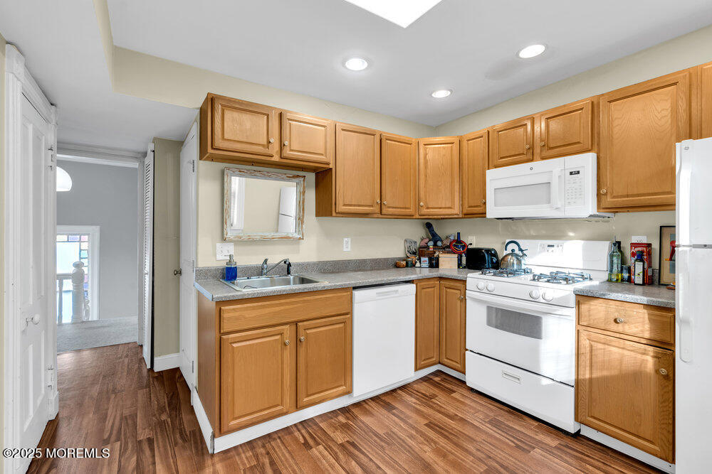 159 Bridge Avenue Red Bank, NJ 07701 - Photo 11 of 39 a kitchen with stainless steel appliances granite countertop a stove a sink dishwasher and a refrigerator with wooden floor