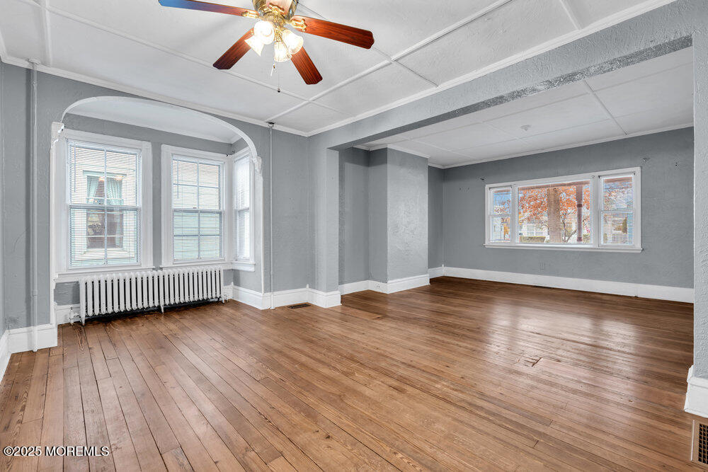 159 Bridge Avenue Red Bank, NJ 07701 - Photo 17 of 39 a view of an empty room with wooden floor and a window