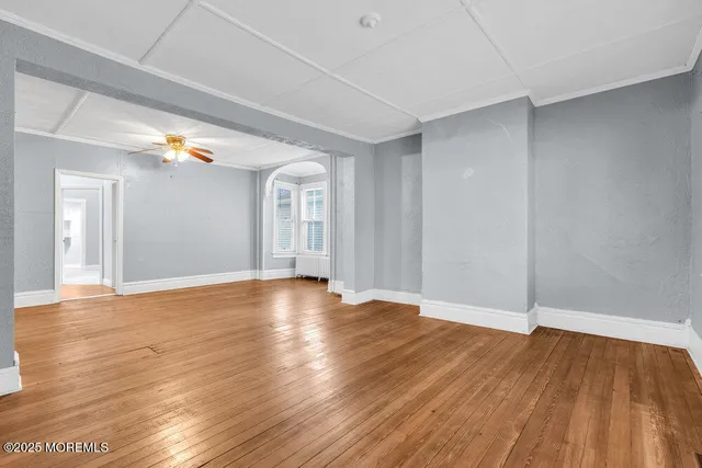 a kitchen with stainless steel appliances granite countertop wooden cabinets a stove a sink and dishwasher with wooden floor