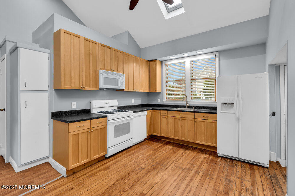 159 Bridge Avenue Red Bank, NJ 07701 - Photo 20 of 39 a kitchen with stainless steel appliances granite countertop wooden cabinets a stove a sink and dishwasher with wooden floor