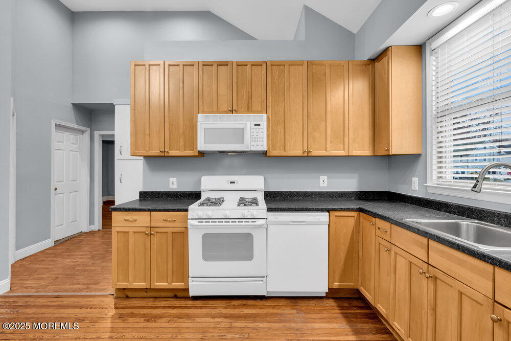 159 Bridge Avenue Red Bank, NJ 07701 - Photo 21 of 39 a kitchen with stainless steel appliances granite countertop wooden cabinets sink and a granite counter top