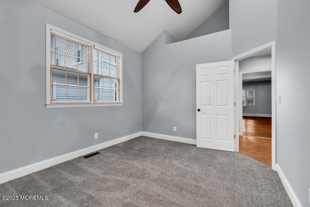 159 Bridge Avenue Red Bank, NJ 07701 - Photo 27 of 39 an empty room with chandelier fan and windows