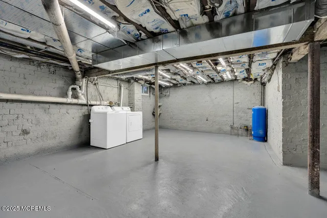 a spacious bedroom with a bed a table and a mirror