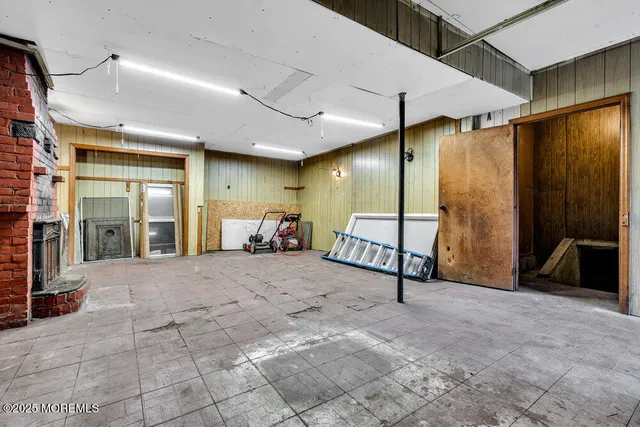 a front view of a house with a garden and trees