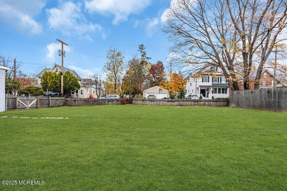 159 Bridge Avenue Red Bank, NJ 07701 - Photo 37 of 39 a front view of a house with garden and trees