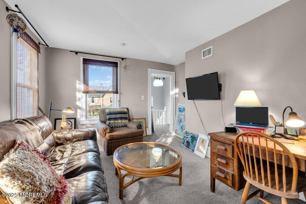 159 Bridge Avenue Red Bank, NJ 07701 - Photo 9 of 39 a living room with furniture a flat screen tv and a window