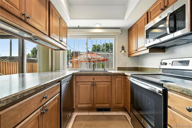a kitchen with stainless steel appliances granite countertop a stove and a microwave