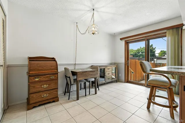 a view of a workspace with furniture and window