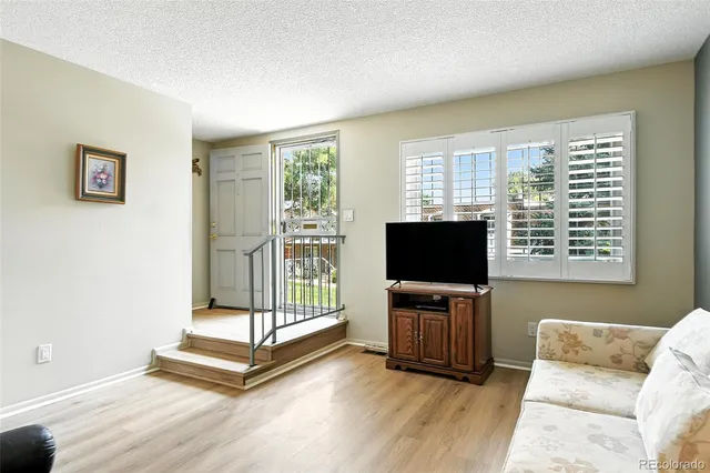 a living room with furniture and flat screen tv