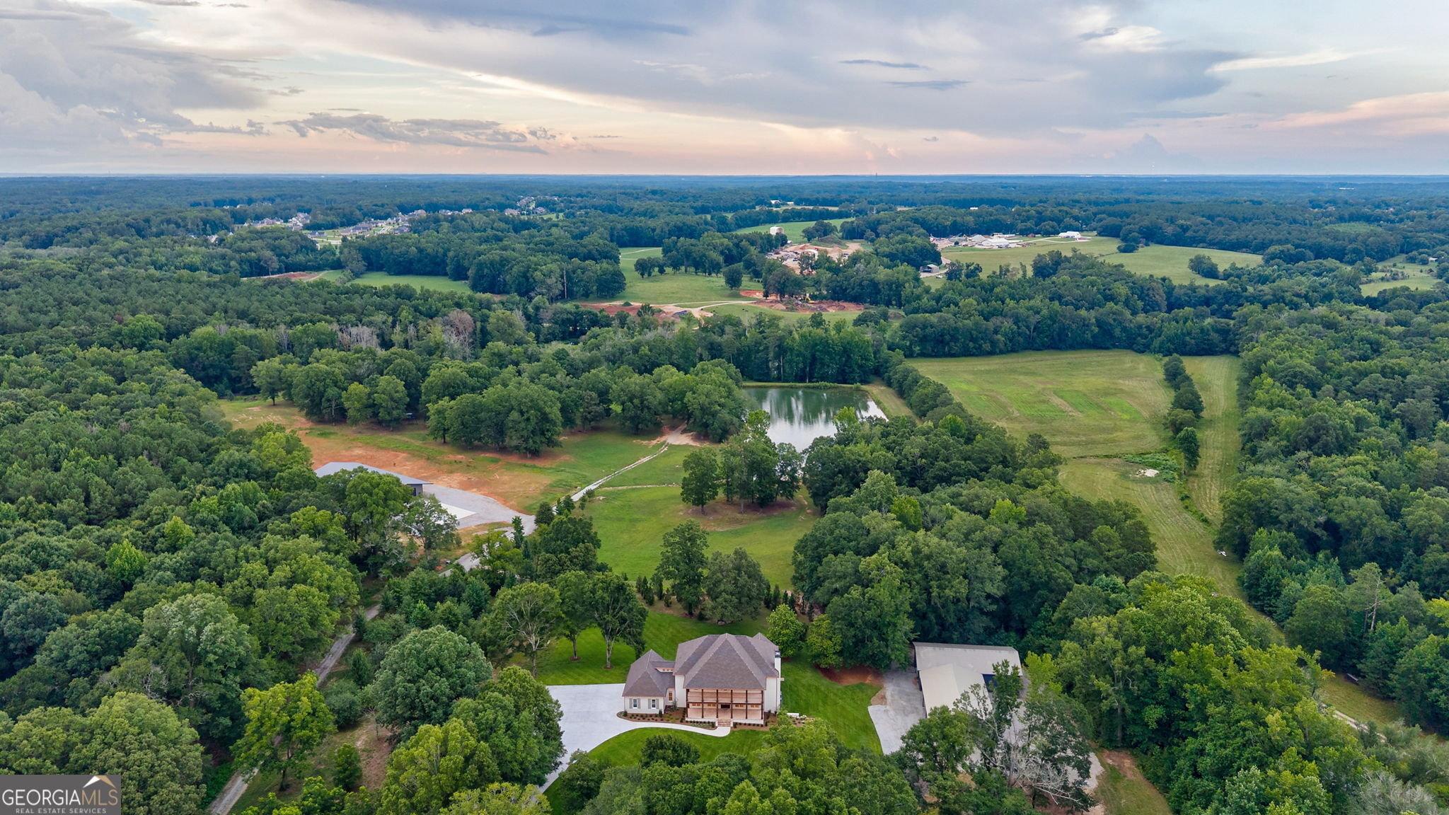 1321 A Garrett Road Statham, GA 30666 - Photo 171 of 176 an aerial view of a house with a garden and lake view