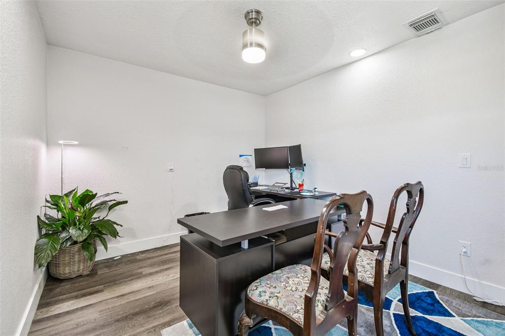 6010 Wall Street Port Richey, FL 34668 - Photo 19 of 43 a view of a workspace with furniture and wooden floor